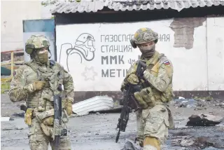  ?? ?? OVERPOWERE­D
Russian servicemen stand guard at the destroyed part of the Ilyich Iron and Steel Works in Ukraine’s port city of Mariupol on Wednesday, May 18, 2022, amid the ongoing Russian military action in Ukraine. AFP PHOTO
Russia can provoke.”