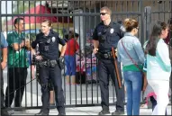  ??  ?? Officers from the Lodi Police Department stand outside the gate at the Lodi Grape Bowl on Saturday.