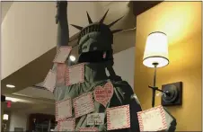  ??  ?? Notes of gratitude written by residents of the Heritage of Green Hills cover a replica of the Statue of Liberty in the community’s restaurant.