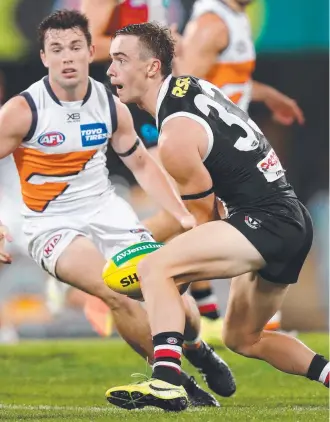  ?? Picture: AFL PHOTOS via GETTY ?? NO ROOM TO MOVE: St Kilda’s Ben Paton shapes to handball against Greater Western Sydney at the Gabba in Brisbane last night.