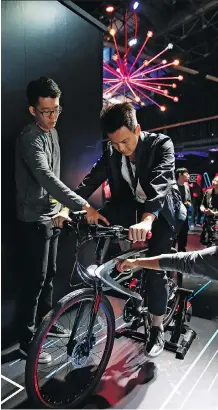  ?? THE ASSOCIATED PRESS ?? LeEco showcases its LeEco Super Bike, an Android smart bike that offers security, connectivi­ty and a smart riding system, during its U.S. launch event in San Francisco last month.