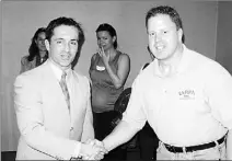  ?? PHOTO SUPPLIED BY JOE SLEMKO ?? Rory Christie (left) shakes hands with Canadian crime-scene expert Joe Slemko after Christie’s release.