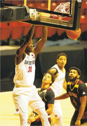  ?? K.C. ALFRED U-T ?? SDSU’s Nathan Mensah dunks for two of his nine points against Saint Katherine on Wednesday night.