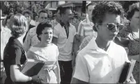  ?? File photo, Will Counts/Arkansas Democrat ?? Students of Central High School in Little Rock shout insults at Elizabeth Eckford walking past a line of National Guardsmen, not shown, who blocked the main entrance of the school on Sept. 4, 1957.