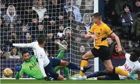  ?? Photograph: Daniel Leal/AFP/Getty Images ?? Leander Dendoncker shoots past Hugo Lloris to score Wolves’ second goal against Tottenham.