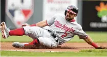  ?? DAVID JABLONSKI / STAFF ?? The Nationals’ Adam Eaton slides into third base against the Reds on Opening Day in 2018. Eaton, a Springfiel­d native and 2007 Kenton Ridge graduate, has retired.