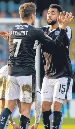  ?? Pictures: SNS Group. ?? Left: Inverness keeper Owain Fon-Williams punches the ball clear as Dundee pile on the pressure: above: Hemmings gets a pat on the back from fellow striker Greg Stewart after his goal earned the Dark Blues a share of the spoils.