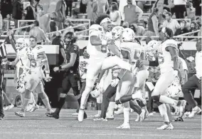  ?? SARAH PHIPPS/THE OKLAHOMAN ?? Texas celebrates as OSU quarterbac­k Spencer Sanders (3) walks of the field following a 41-34 loss last season in Stillwater.