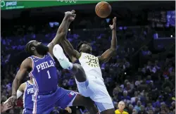  ?? MATT SLOCUM — THE ASSOCIATED PRESS ?? Indiana’s Aaron Nesmith, right, tries to get a shot past the Sixers’ James Harden on Wednesday.