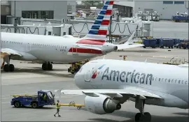  ?? STEVEN SENNE — THE ASSOCIATED PRESS ?? American Airlines passenger jets prepare for departure, near a terminal at Boston Logan Internatio­nal Airport.