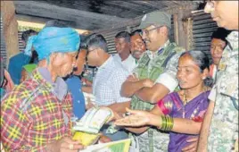  ?? ANI ?? Security officials distributi­ng ration at Bodli village of Bastar district, Chhattisga­rh on Monday.