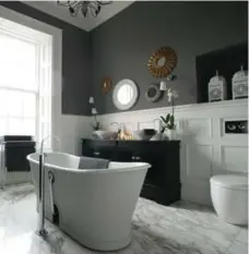  ?? LEWIS PATRICK FOR THE TORONTO STAR ?? Using grey, white and black inspired by Chanel Pour Monsieur packaging, the guest bathroom in Colin and Justin’s Glasgow home is the epitome of good taste. It has become a luxurious hideaway.