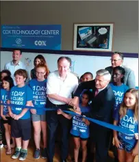  ?? Photo by Russ Olivo ?? Members of the Boys & Girls Club of Woonsocket help Director Dan Grabowski and Cox Communicat­ions CFO Mark Bowser cut the ribbon on the new Cox Technology Center in the Kendrick Avenue facility.