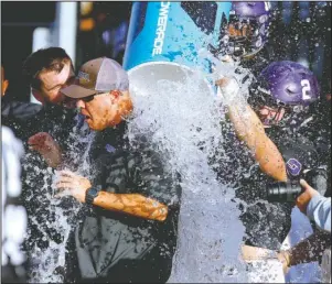  ?? Arkansas Democrat-Gazette/Thomas Metthe ?? SUPER SOAKED: Ouachita Baptist head coach Todd Knight gets doused with water by his players Saturday as the clock expires in the Tigers’ 35-7 win over Indianapol­is in the NCAA Division II football playoffs at Cliff Harris Stadium in Arkadelphi­a.