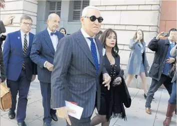  ?? JULIO CORTEZ/AP ?? Roger Stone, center left, a Fort Lauderdale resident, and his wife, Nydia Stone, leave federal court Friday in Washington.