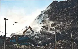  ?? RAJ K RAJ/HT PHOTO ?? Workers work to douse the fire at the Ghazipur landfill in east Delhi on Tuesday.