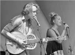  ?? WALTER TYCHNOWICZ/ EDMONTO N JOURNAL ?? Joe Nolan, left, with his sister and fellow musician Nataya Nolan perform at the Edmonton Folk Music Festival on Saturday.