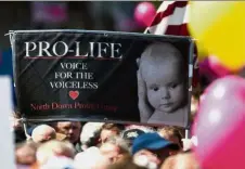  ?? — AFP ?? Deeply divided: Anti-abortion supporters holding up a placard during a rally calling for a ‘no’ vote in Dublin.