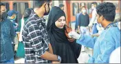  ?? ?? A health worker collects swab samples of a passenger for Covid19 test at Dadar station, in Mumbai on Dec 31.