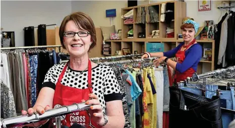  ??  ?? GRAB A BARGAIN: Toowoomba Red Cross Shop manager Charmaine Renner and assistant manager Rachel Bailey look over stock in the new store. PHOTOS: BEV LACEY