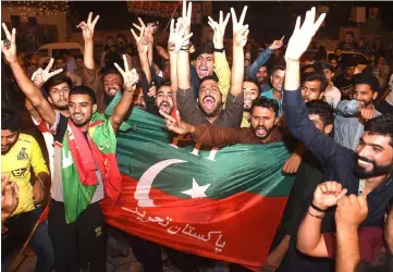  ?? — AFP photo ?? Supporters of Khan celebrate during general election in Lahore.