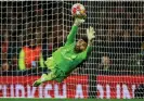  ?? Photograph: Hannah McKay/Reuters ?? David Raya in action during the shootout, where he saved two of Porto’s four penalties.