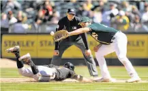  ?? D. Ross Cameron / Special to The Chronicle ?? The Giants’ Gregor Blanco slides safely back into first base as Olson takes a pickoff throw in an exhibition game last month.