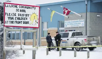  ?? THE CANADIAN PRESS/FILES ?? Members of the RCMP stand outside the La Loche Community School in La Loche on Jan. 25, 2016, the day of the shootings. The teen who pleaded guilty in the case will be sentenced on Friday.