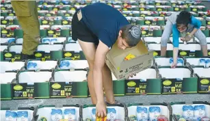  ?? (Michael Giladi/Flash90) ?? SOLDIERS AND volunteers pack boxes with food for families in need ahead of Rosh Hashanah and Sukkot earlier this month in Avney Eitan, Golan Heights, organized by the Horowitz family in memory of their son Eylon who died during his military service.