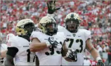  ?? JAY LAPRETE — ASSOCIATED PRESS FILE ?? Army running back Darnell Woolfolk, center, celebrates his touchdown against Ohio State with teammates Ahmad Bradshaw, left, and Jaxson Deaton during a September 2017 game in Columbus, Ohio. The senior rushed for 1,412 yards and 23 scores over the last two seasons.