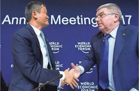  ?? EUROPEAN PRESSPHOTO AGENCY ?? Jack Ma, left, and Internatio­nal Olympic Committee President Thomas Bach greet each other Thursday in Davos, Switzerlan­d.