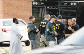  ?? David Joles / Minneapoli­s Star Tribune ?? Law enforcemen­t officers investigat­e an explosion at a mosque in Bloomingto­n, Minn.