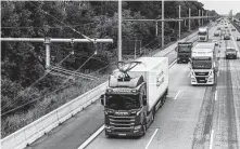  ?? Felix Schmitt / New York Times ?? A truck draws electric power from overhead wires as it is driven along a highway near Erzhausen, Germany.