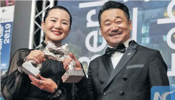  ?? Photo: Xinhua ?? Chinese actor Wang Jingchun (right), and actress Yong Mei pose for photos during a press conference of the 69th Berlin Internatio­nal Film Festival in Berlin, capital of Germany on February 16, 2019.