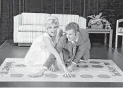  ?? Carlos Ortiz / Democrat & Chronicle via Associated Press ?? Rochester residents Lauren Sodano and Shawn Gray portray Eva Gabor and Johnny Carson playing Twister at the National Toy Hall of Fame.