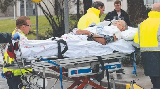  ??  ?? Shark attack victim Dave Quinlivan arrives at the John Hunter Hospital in Newcastle.