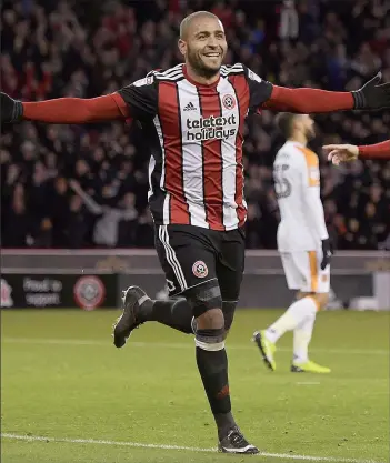  ??  ?? THREE’N’EASY: Leon Clarke wheels away after scoring his hat-trick goal