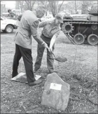  ?? The Sentinel-Record/Richard Rasmussen ?? DEDICATION: Hot Springs Mayor Pat McCabe, left, and Regine Skelton, a county forester and urban representa­tive with the Arkansas Forestry Commission, toss dirt on a willow oak tree at the Garland County Veterans Memorial and Military Park on Monday...