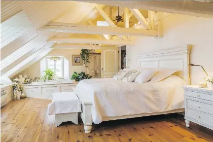  ?? PHOTOS: PERRY MASTROVITO ?? A whirlpool tub for two, back left, is a luxurious feature in the white-toned master bedroom, reclaimed from the old attic.