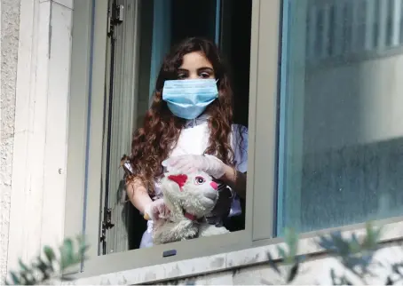  ?? Reuters ?? A Lebanese girl, who was stranded abroad by coronaviru­s lockdowns is quarantine­d at a hotel while awaiting results for COVID-19 in Beirut on Wednesday.