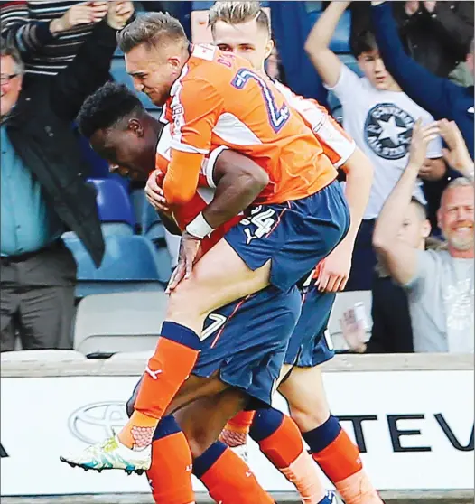  ?? PICTURES: Dan Westwell ?? GIDDY UP! Lawson D’Ath leaps on the back of Luton goalscorer Pelly-Ruddock Mpanzu