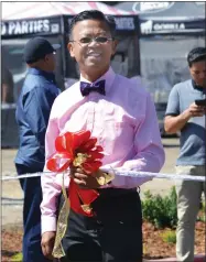  ?? RECORDER PHOTO BY ALEXIS ESPINOZA ?? Francis Cunanan, M.D. proudly holds the ribbon for the ceremonial ribbon cutting held on Tuesday afternoonf­or he and his wife’s new clinic, Family Medicine Clinic, on Villa Street.