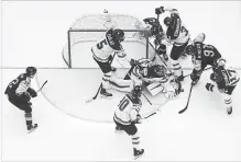  ?? MARTIN ROSE GETTY IMAGES ?? Canadian goalie Darcy Kuemper is surrounded against Germany in a world hockey championsh­ip contest in Denmark.