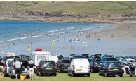  ??  ?? A sea of cars: Vehicles above Polzeath Beach