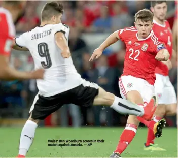  ?? — AP ?? Wales’ Ben Woodburn scores in their match against Austria.