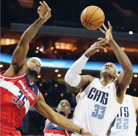  ??  ?? Going for it: Washington Wizards’ Trevor Booker (left) and Charlotte Bobcats’ Brendan Haywood battling for the ball during their game at the Time Warner Cable Arena in Charlotte, North Carolina, on Saturday. — AFP