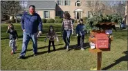  ?? BEN HASTY — MEDIANEWS GROUP ?? Ryan and Amy Parsons with their children Park, 6, Sadi, 4, and Max, 8, check the mailbox for Letters to Santa outside their house each day.