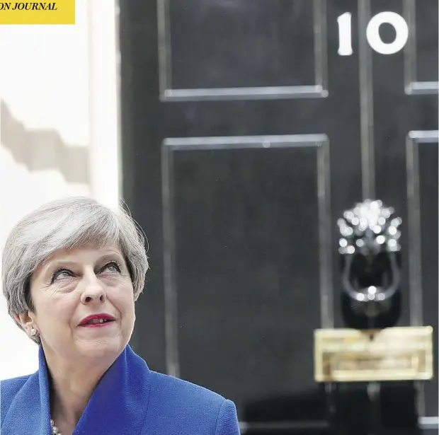  ?? JONATHAN BRADY/PA VIA AP) ?? Theresa May speaks to the media outside 10 Downing Street in London on Friday, The British prime minister’s gamble in calling an early election backfired spectacula­rly as her Conservati­ve Party lost its majority in Parliament, throwing British politics...