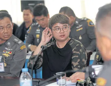  ?? APICHART JINAKUL ?? Potchakorn, or Methawat, Khonman is brought for questionin­g by the Crime Suppressio­n Division after she was arrested and charged in connection with a lottery investment scam.