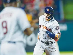 ?? (Reuters) ?? )06450/ "45304 shortstop Carlos Correa yells as he circles the bases after his three-run home run during the Astros’ 7-1 romp over the Texas Rangers in Arlington on Friday.